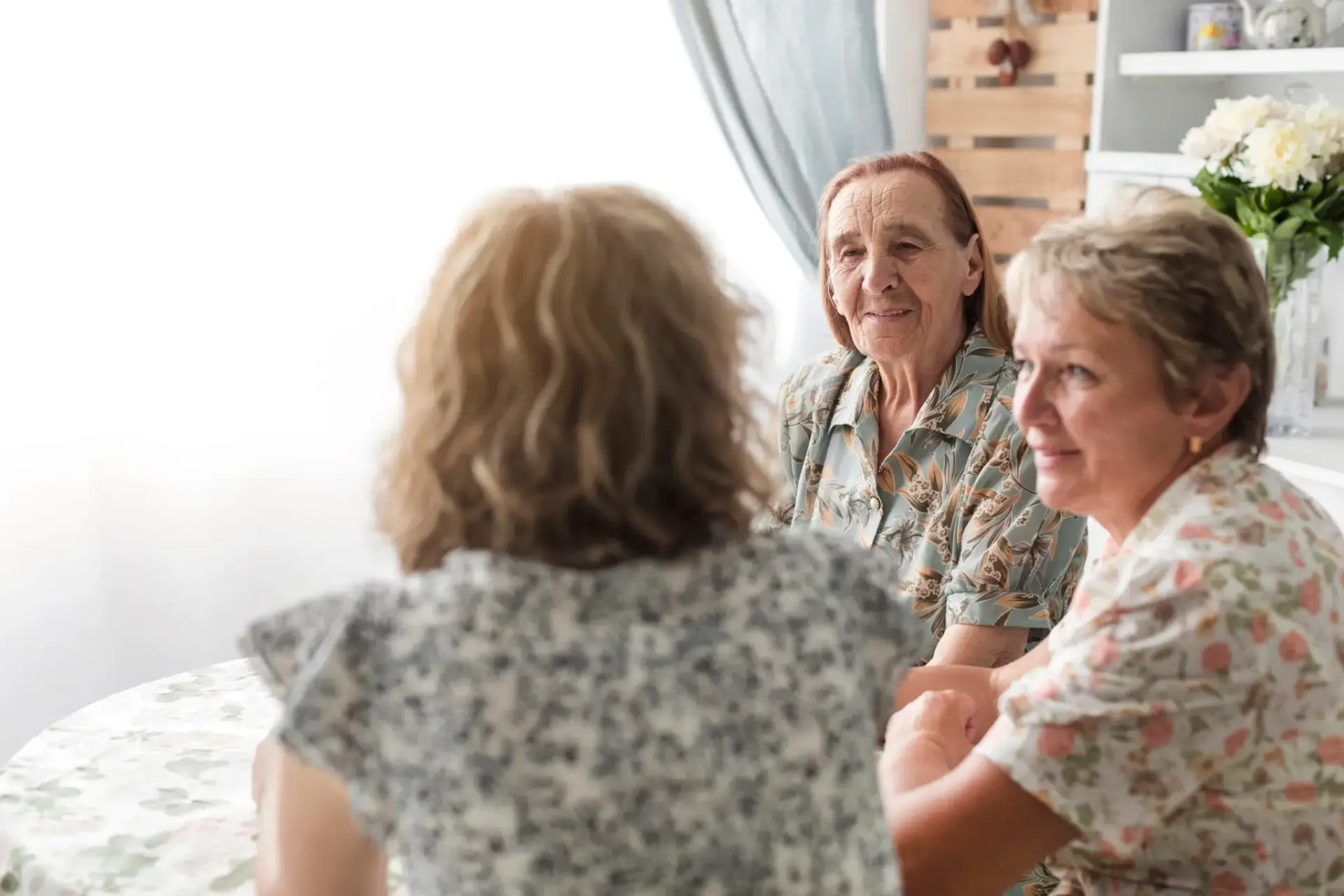 woman-with-her-mother-granny-sitting-together-kitchen-scaled